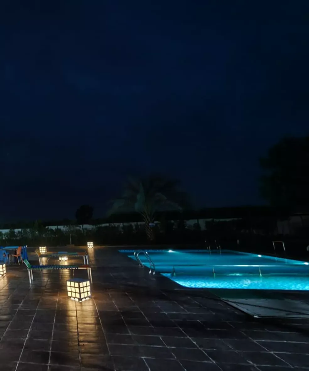 Infinity pool at Waje Farm House at night