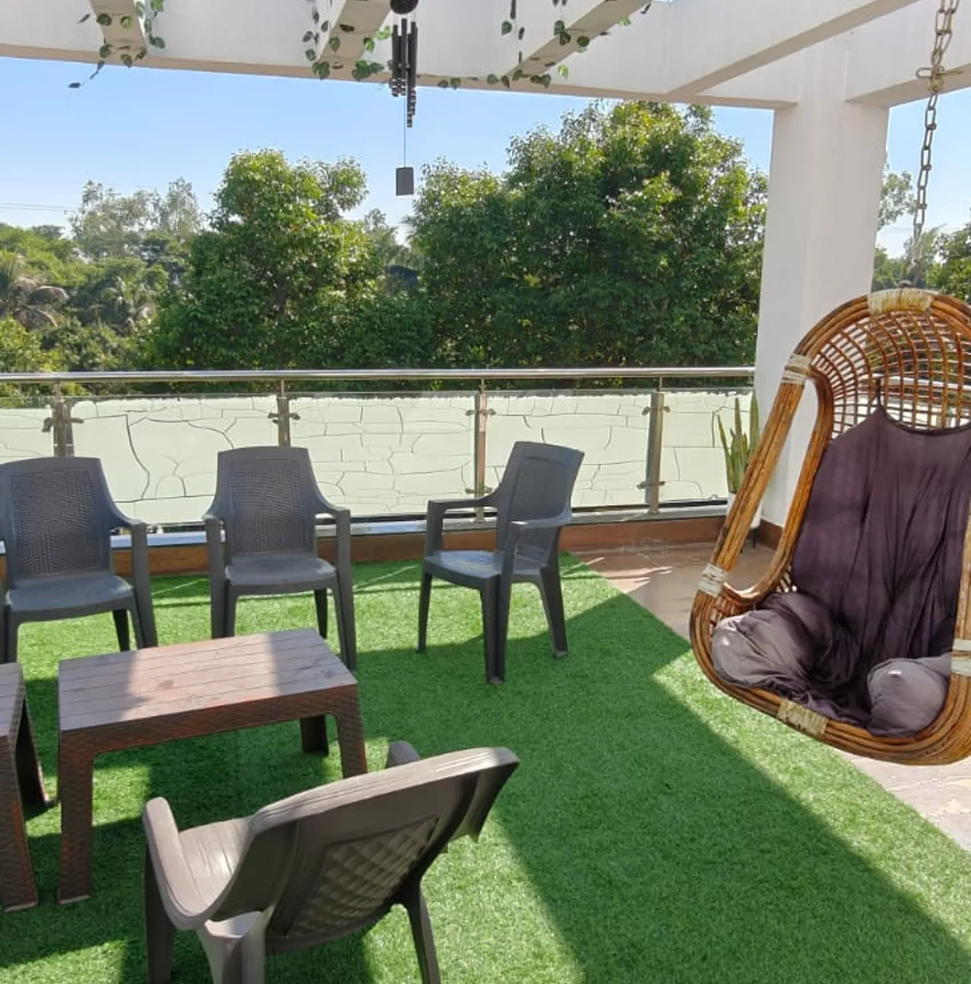 Outdoor balcony lounge at Waje Farm House